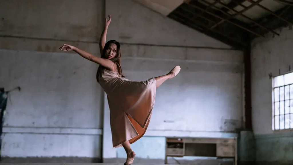 Woman dancing alone in an open space, embodying strength, confidence, and emotional release.