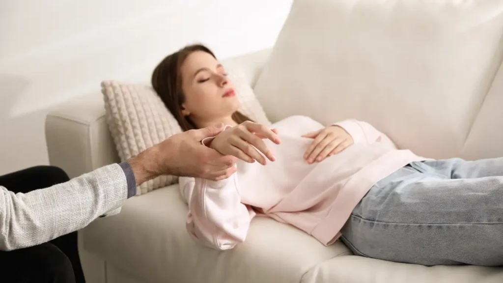 Woman in a hypnotherapy session receiving gentle subconscious guidance.